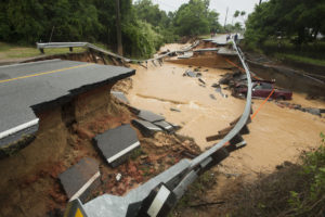 Damage due to flash flooding is seen along Johnson Ave. in Pensacola, Florida, April 30, 2014. A state of emergency was declared on Wednesday in Pensacola's Escambia County where emergency officials fought to save motorists stranded by flood waters. REUTERS/Michael Spooneybarger (UNITED STATES - Tags: ENVIRONMENT DISASTER) - RTR3NB8P