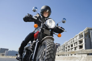 Woman riding motorcycle in city
