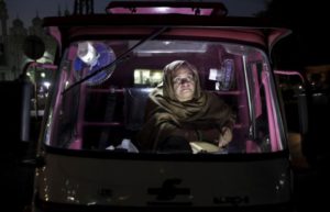 Parveen Bibi sits in her Pink Rickshaw as she waits for passengers in Lahore, Pakistan November 17, 2015. REUTERS/Mohsin Raza